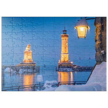 Darstellung des Puzzle Motivs puzzleplate Hafeneinfahrt mit Leuchtturm und Löwenstatue an einem Winterabend, Lindau 100 Puzzle