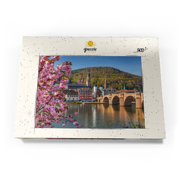 Darstellung des Puzzle Motivs Japanische Zierkirsche am Neckarufer mit Blick zur Heidelberger Altstadt und Alte Brücke 500 Puzzle Schachtel Ansicht3