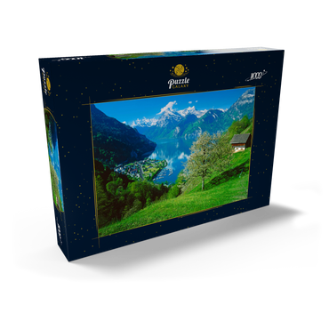 Darstellung des Puzzle Motivs Blick auf das Dorf am See gegen Gitschen und Urirotstock 1000 Puzzle Schachtel Ansicht2