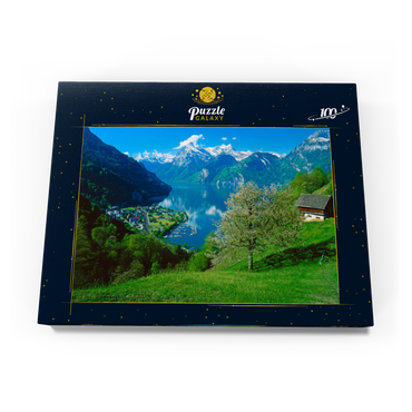 Darstellung des Puzzle Motivs Blick auf das Dorf am See gegen Gitschen und Urirotstock 100 Puzzle Schachtel Ansicht3