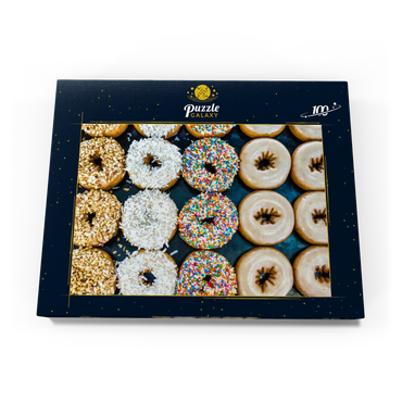 Darstellung des Puzzle Motivs Frische Donuts mit verschiedenen Belägen aus der örtlichen Bäckerei. 100 Puzzle Schachtel Ansicht3