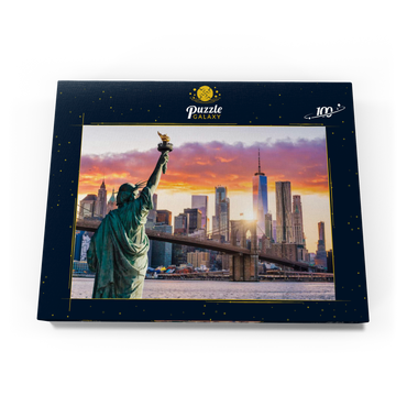 Freiheitsstatue und New Yorker Stadtsilhouette bei Sonnenuntergang, USA 100 Puzzle Schachtel Ansicht3