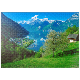 Darstellung des Puzzle Motivs Blick auf das Dorf am See gegen Gitschen und Urirotstock - Puzzleteile: 1000