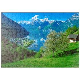 Darstellung des Puzzle-Motivs Blick auf das Dorf am See gegen Gitschen und Urirotstock – Puzzleteile: 200
